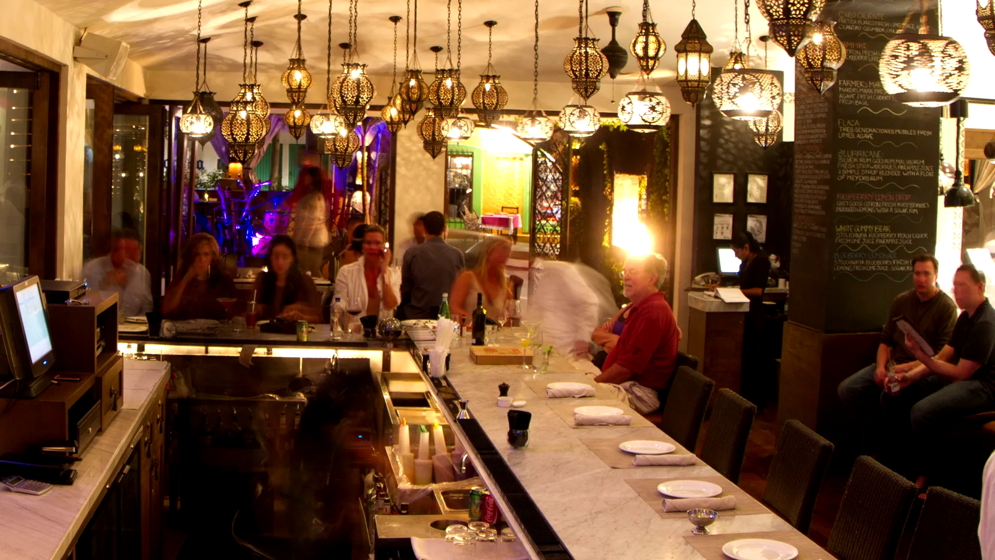 A busy bar under glowing lanterns