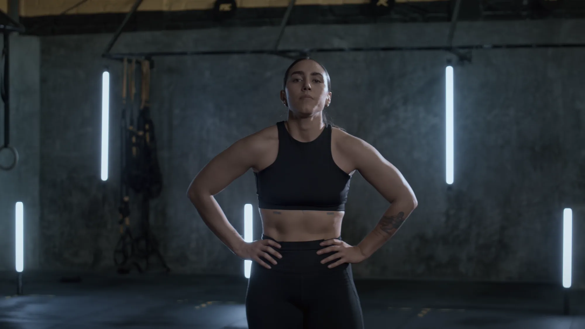 Coach Maya standing in the gym