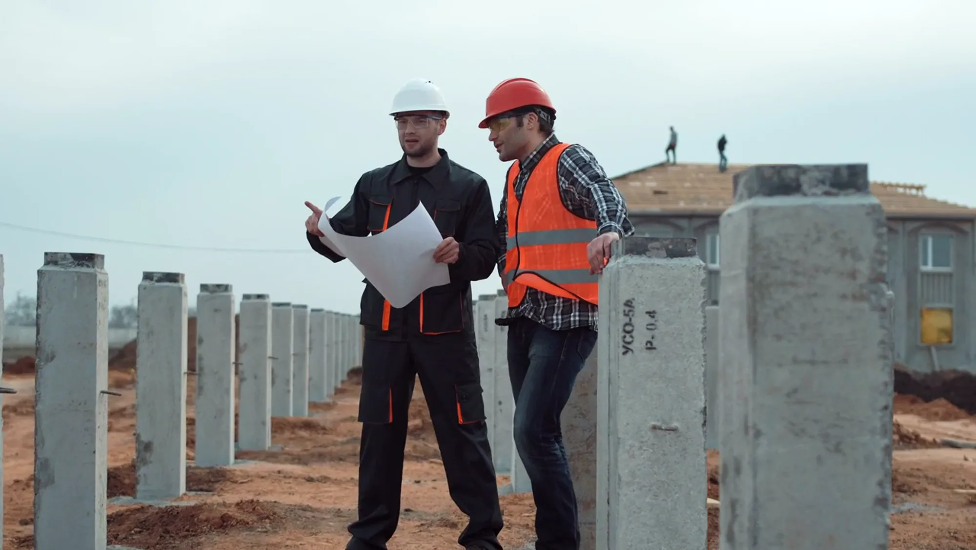 Builders reviewing plans on site