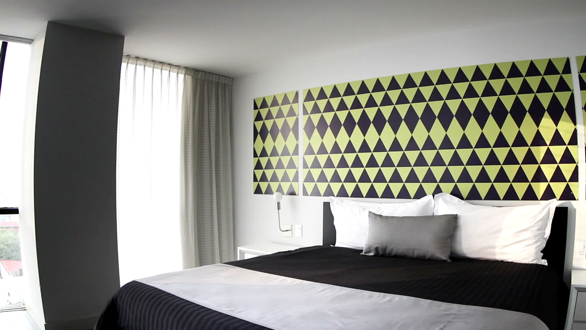 A finished bedroom with large windows