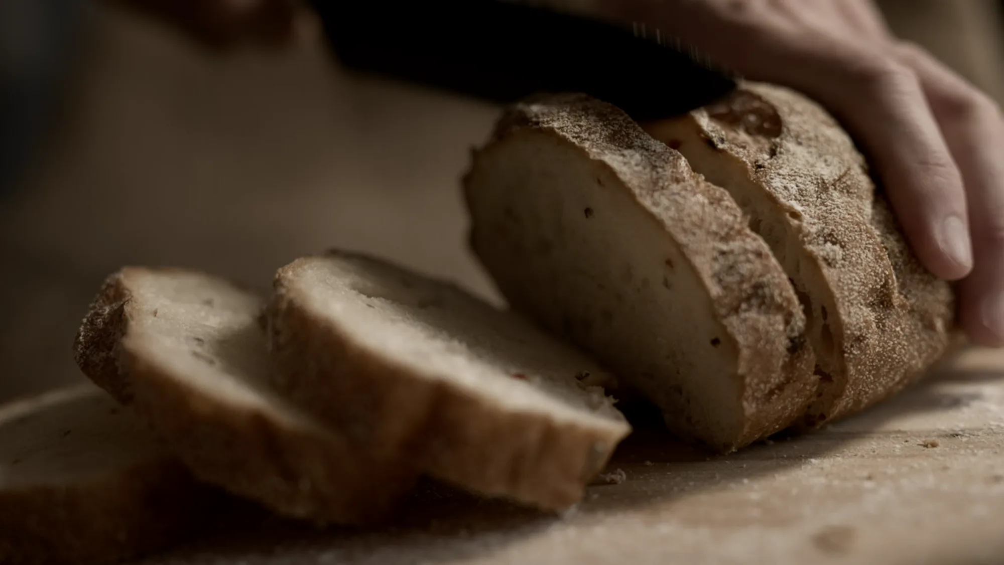 Country sourdough loaf being sliced